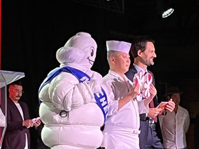Chef Masaki Saito of Sushi Masaki Saito, centre, poses with his two Michelin stars at a Toronto gala in mid-September 2022. At that event, the Michelin Guide’s Gwendal Poullennec, right, revealed the restaurants singled out for praise in the Michelin Guide’s inaugural survey of Toronto