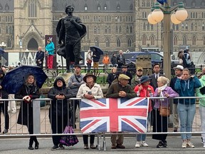 OTTAWA – Sept. 19, 2022 – Veronica Downing, in the white jacket, and her husband Graham, on her left, arrived in Ottawa on Sunday to attend a conference. The Suffolk, England residents rang the bells in their church for the Queen on Friday, following her death.