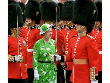 Queen Elizabeth II inspects a Guard of Honor after her arrival on Parliament HIll in Ottawa, July 1, 1990, to take part in Canada Day ceremonies.