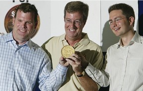 FILE PHOTO: John Baird, Jim Watson, and Pierre Poilievre hold up an oversized loonie as they announce the one-dollar-per-year rent at the Queensway Carleton Hospital in 2006.