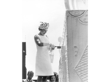 Queen Elizabeth II cuts the centennial cake on Parliament Hill in 1967.