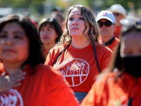 Mekwan Tulpin, from Fort Albany First Nation near James Bay, has tears in her eyes as she listens to a powerful poem read by a residential school survivor during Friday’s event at LeBreton Flats.