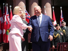 Sylvia Jones, Ontario's minister of health, shakes hands with Premier Doug Ford as she is sworn in at Queen's Park in late June.