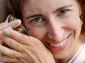 University of Ottawa researcher Heather Kharouba poses with a monarch butterfly at Carleton University on Thursday.