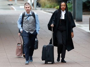 TUPOC director William Komer arrives at the Ottawa courthouse with his lawyer Saron Gebresellassi Monday.