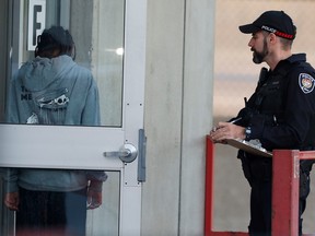 A young woman talks to an Ottawa Police Service officer at the scene after the stabbing incident at the St. Laurent Shopping Centre on Friday afternoon.