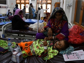 A woman, who became a flood victim, takes care of her ailing baby at a hospital, following rains and floods during the monsoon season in Jamshoro, Pakistan September 20, 2022.