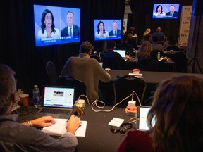 Reporters listen to Liberal Leader Dominique Anglade and CAQ Leader Francois Legault square-off during the Quebec election leaders debate in Montreal, on Thursday, September 15, 2022.