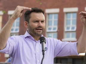 Parti Québécois Leader Paul St-Pierre Plamondon responds to questions during a campaign stop in front of a school under renovation in Montreal, Friday, Sept. 9, 2022. Plamondon says he fully supports a candidate who appeared in an explicit video.