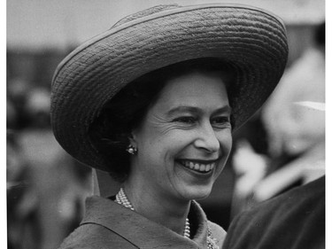 A straw hat shades the Queen's face as she boards the Royal Yacht Britannia in Cornwall after Sunday's church service in Ottawa. July 1967