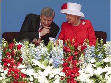 Queen Elizabeth speaks with Canadian Prime Minister Stephen Harper as they wait for Canada Day festivities on Parliament Hill in Ottawa, Thursday July 1, 2010.