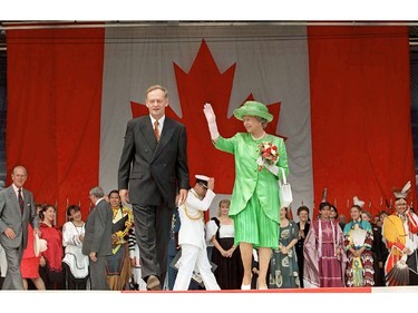 Queen Elizabeth waves to supporters as she walks off the stage with Prime Minister Jean Chretien following Canada Day Ceremonies in Ottawa Tuesday.