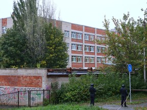 Police officers secure the area near a school after a gunman opened fire there, in Izhevsk, Russia September 26, 2022.