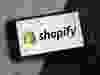 The Shopify Inc. logo displayed on a smartphone.