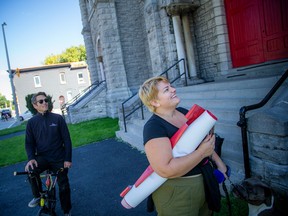 Erica Lackey, a TUPOC counter-protester, happily accepted one of the banners that fell from the front of the former St. Bridget Church building on Saturday.