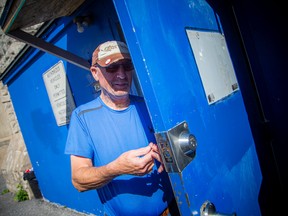 Francis Healy changes a lock at Old St. Brigid's Church in Lowertown on Saturday.