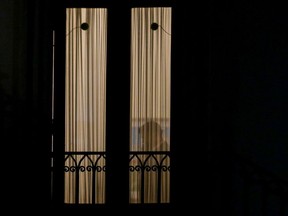 Chile´s President Gabriel Boric is seen talking on the phone from a window at La Moneda Presidential palace after the polling closed for a plebiscite on whether or not a new Constitution will replace the current Magna Carta imposed by a military dictatorship 41 years ago, in Santiago, Chile, Sunday, Sept. 4, 2022.