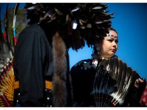 Seventeen-year-old Georgia Mianskum in a woman’s traditional regalia was getting ready for the grand entry of the powwow at the farm Sunday.