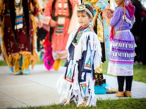 Four-year-old Leo Andrades, was getting prepared for the powwow wearing his grass dancer regalia.