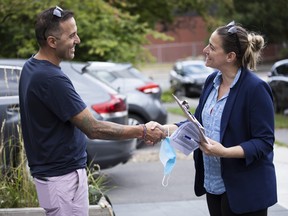 Rideau-Vanier council candidate Stéphanie Plante speaks with a ward resident as she campaigns.