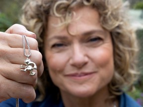 Montreal writer Monique Polak told the story of the “monkey man” charm with the goal of spreading its message of hope and humanity to a wider audience. Above, she holds a silver replica.