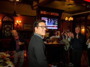 Wilson Lo, newly elected councillor for Ward 24, Barrhaven East, celebrates with supporters at the Heart & Crown Irish Pub in Barrhaven on Monday night.