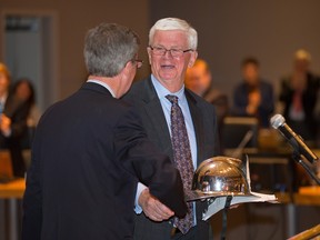 File photo: Outgoing Ottawa city councillor Doug Thompson is congratulated by Mayor Jim Watson after he gives his goodbye speech during a council meeting. In 2014, Thompson had announced he would retire.