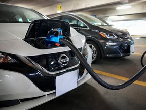 Electric vehicles are displayed before a news conference in Washington.