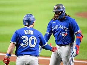 BALTIMORE, MARYLAND - OCTOBER 03: Vladimir Guerrero Jr. #27 of the Toronto Blue Jays celebrates with Alejandro Kirk #30 after hitting a home run in the third inning against the Baltimore Orioles at Oriole Park at Camden Yards on October 03, 2022 in Baltimore, Maryland.