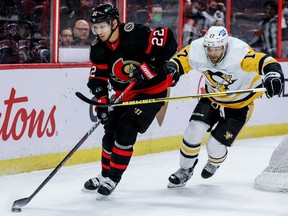 Ottawa Senators defenceman Nikita Zaitsev (22) eludes the check of Pittsburgh Penguins right wing Bryan Rust (17) during second period NHL action at the Canadian Tire Centre on February 10, 2022.