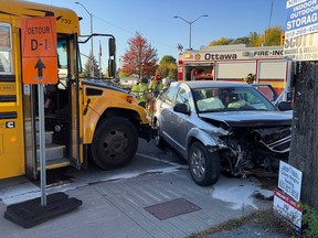 OTTAWA --Ottawa Fire Services clean up debris following an accident involving a car and a school bus at the intersection of Manotick Main Street and Bridge Street in Manotick on Wednesday, Oct. 5, 2022. ERROL MCGIHON, Postmedia