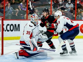 Ottawa Senators right wing Drake Batherson (19) reaches to just missing a goal as Washington Capitals right wing Garnet Hathaway (21) and goaltender Darcy Kuemper (35) defend during third period NHL action at the Canadian Tire Centre on October 20, 2022.