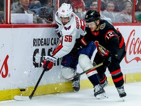 Ottawa Senators right wing Alex DeBrincat (12) and Washington Capitals defenceman Erik Gustafsson (56) during third period NHL action at the Canadian Tire Centre on October 20, 2022.