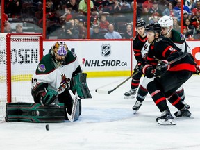 Ottawa Senators centre Josh Norris (9) and Arizona Coyotes goaltender Karel Vejmelka (70) track a rebound during third period NHL action at the Canadian Tire Centre on Oct. 22, 2022.