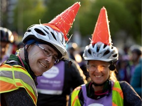 The Poirier family of Ottawa sport light-up construction cones during the Tour la Nuit in Montreal on May 31, 2019. The orange cone is now Montreal's unofficial city symbol, writes Josh Freed.