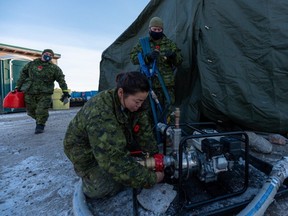 Members of the Canadian Armed Forces ready a water pump in Iqaluit, Nunavut, on Wednesday, November 10, 2021.