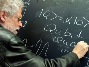 (FILES) In this file photo taken on June 07, 2012 Austrian physicist Anton Zeilinger writes a Qubit on a blackboard during a preview of the dOCUMENTA (13) fair for contemporary art in Kassel, central Germany.