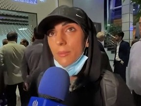 This image grab from footage obtained from Iranian State TV IRIB on October 19, 2022 shows Elnaz Rekabi, an Iranian climber who caused a sensation by competing at an event abroad without a hijab, giving an interview upon her arrival at Imam Khomeini International Airport in Tehran.