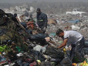Waste recyclers look through heaps of waste at a landfill for cardboard, plastic and metal, which they sell while working 12-hour shifts, as Argentina faces one of the world's highest inflation rates, set to top 100% this year, in Lujan, on the outskirts of Buenos Aires, Argentina October 5, 2022.