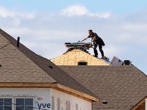 A construction worker works on a new home in Ottawa. We demonize developers for building housing while we ask for more housing to be built.