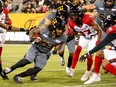 Tiger-Cats running back Sean Thomas Erlington carries the ball into the heart of the Redblacks' defence during the first half of Friday's game at Hamilton.