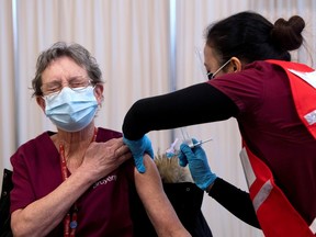 A file photo shows a personal support worker receiving a COVID-19 vaccination in Ottawa in December 2020.