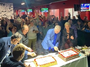 Tim Tierney cuts the cake after he is declared the victor for Ward 11, Beacon Hill-Cyrville, at the Richview Sensplex on Monday, Oct. 24, 2022.