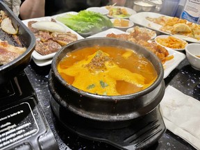 Spicy pork bone soup in the foreground at Korean House in Ottawa’s Chinatown