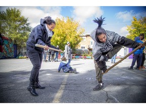 Damian Metcalf, right, demonstrates his agility at the Inuit Olympics in Vanier on Saturday.