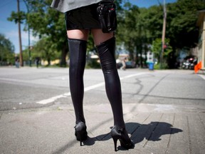 A sex trade worker is pictured in downtown Vancouver, in this file photo. Sex workers have taken the federal government to court over legislation they say makes it dangerous to earn their livelihood.