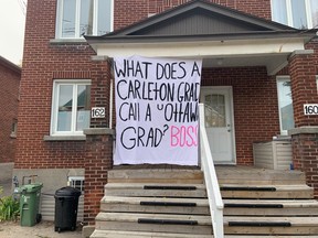 A sign painted on bedsheets and displayed at a Sandy Hill house delivers a uOttawa jab at Carleton.