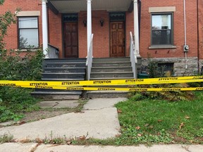 Caution tape surrounds a sandy hill on Saturday afternoon.