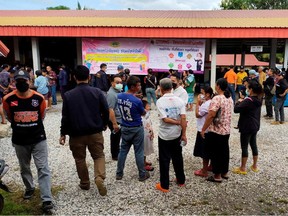 People gather outside of a daycare center's scene of a mass shooting in the town of Uthai Sawan, 500 km (310 miles) northeast of Bangkok in the province of Nong Bua Lamphu, Thailand October 6, 2022.