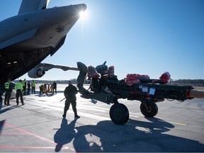 File photo: A battery of Canadian M777 howitzers, TAPV armoured vehicles and related equipment is unloaded at the airport in Riga, Latvia.